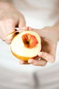 WomanÃ¢â¬â¢s hands pare red apple Royalty Free Stock Photo